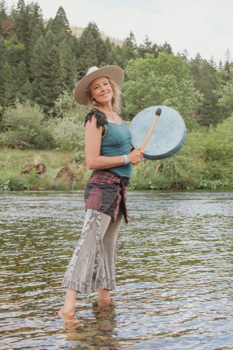 Maura drumming in a river