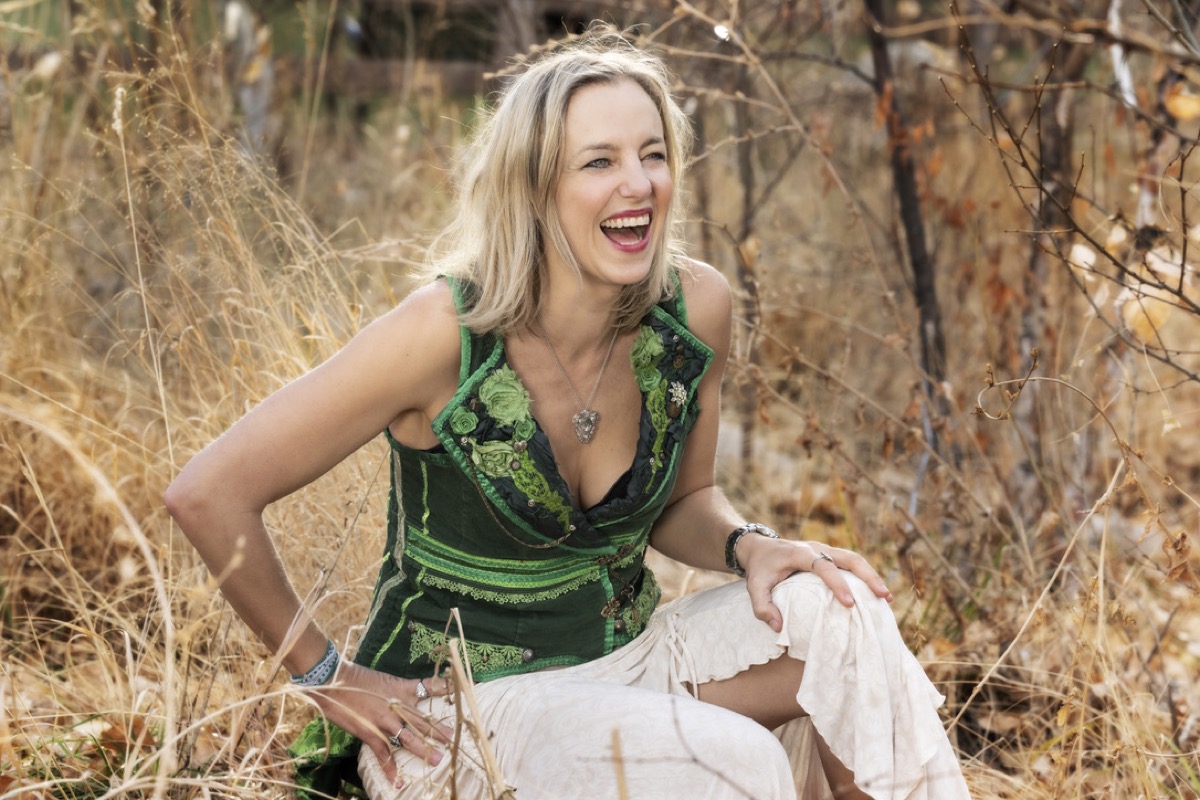 Maura laughing in the grass